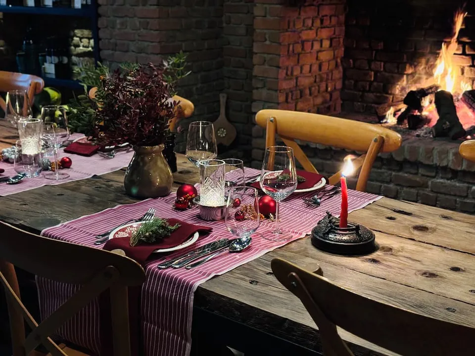 Dinner table by the fireplace at Karnas