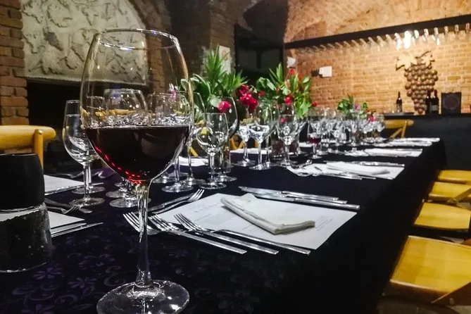 A glass of red wine on the tasting table in the Karnas cellar